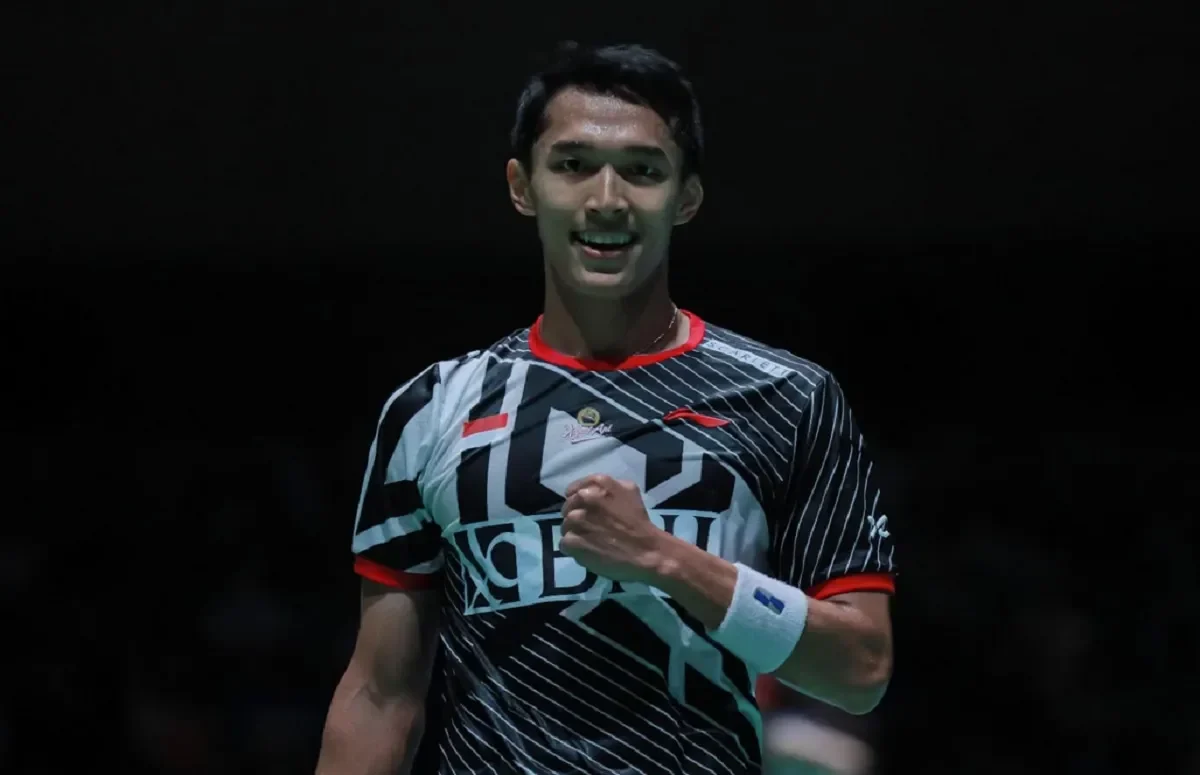 Alwi Farhan, tunggal putra Indonesia, tersenyum dan mengepalkan tangan di lapangan bulutangkis.