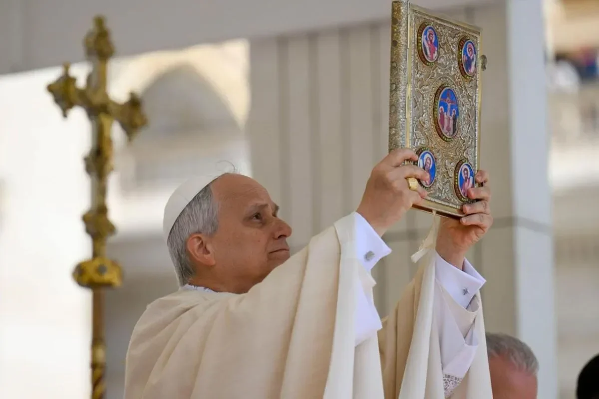 Paus mengangkat kitab suci berhias indah di Vatikan.