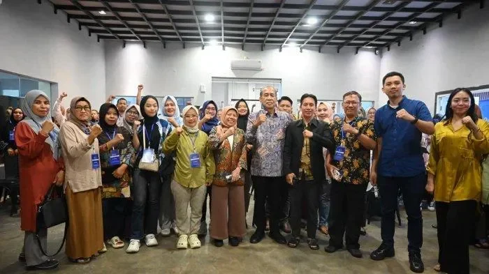 Kelompok yang berpose mengangkat kepalan tangan sebagai tanda solidaritas dan komitmen.