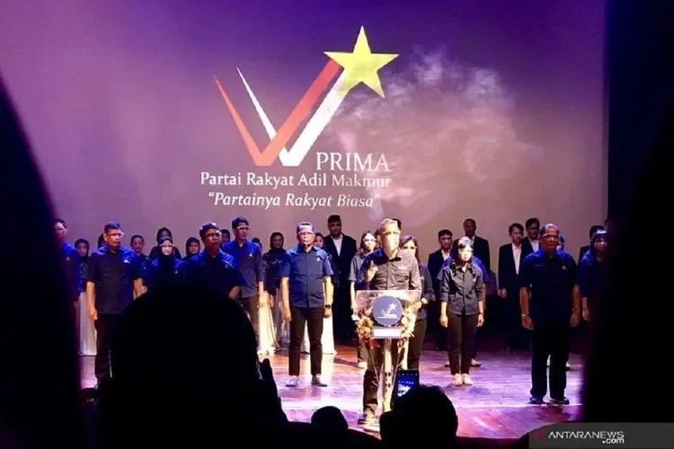 Seorang pria berbicara di podium di hadapan anggota partai dalam sebuah acara.