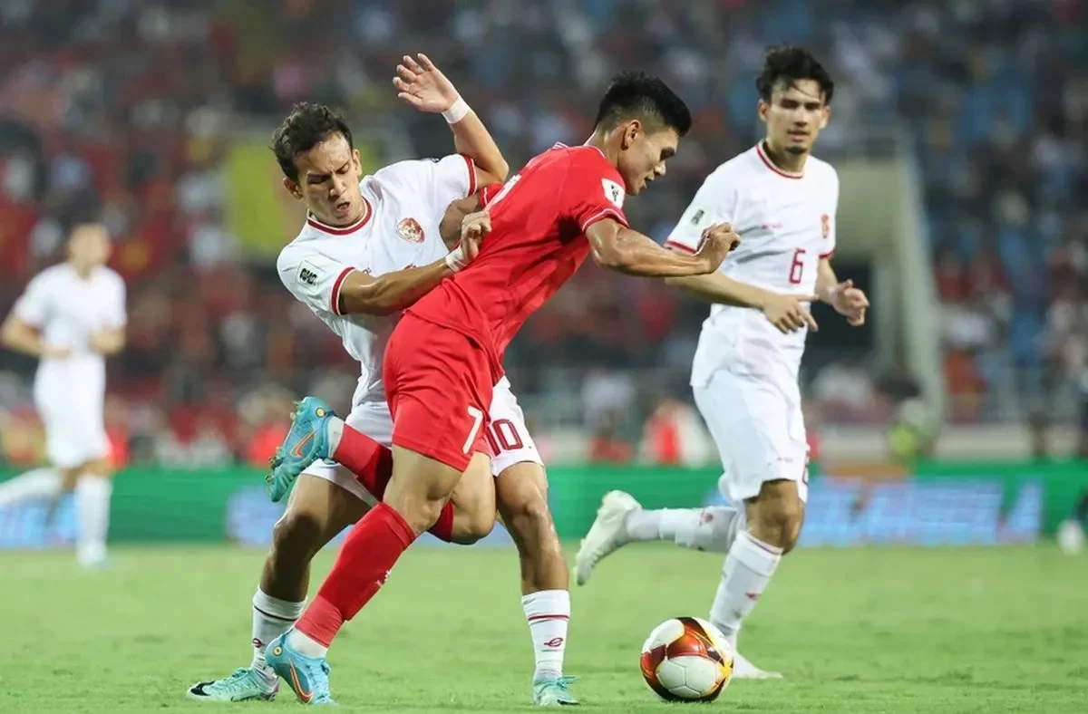 Pemain sepak bola bertarung memperebutkan bola di lapangan hijau saat pertandingan kualifikasi Piala Dunia.