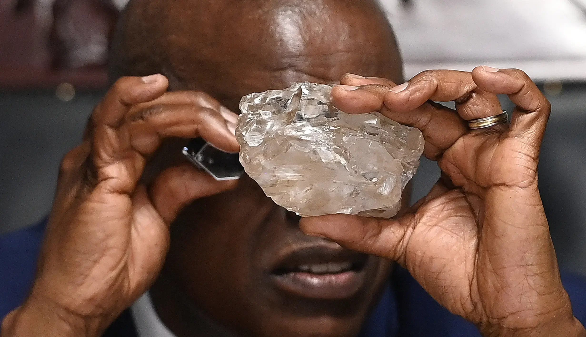 Seorang ahli memeriksa berlian raksasa Motswedi yang belum dipotong dengan loupe.