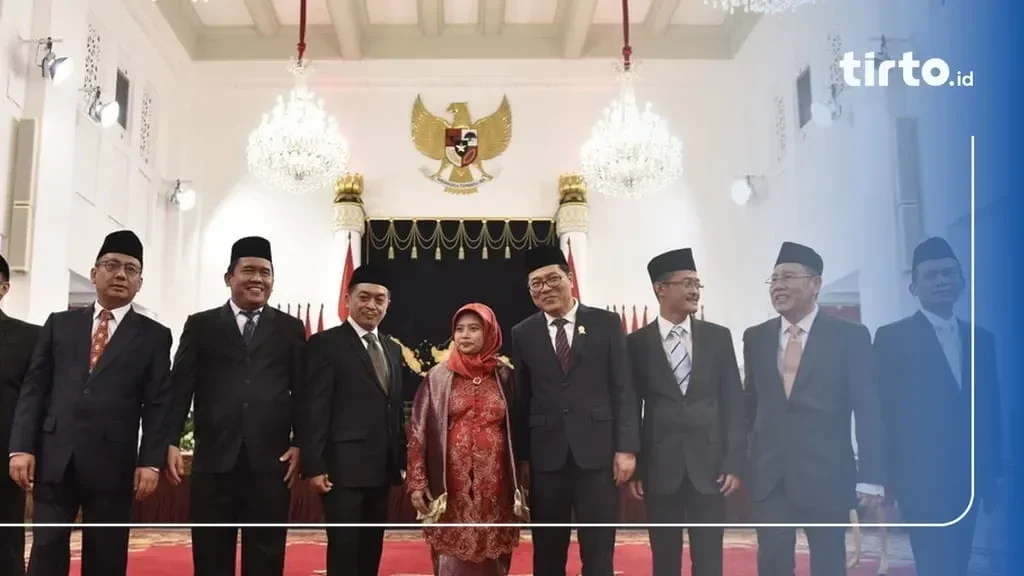 Jajaran Komisioner KPPU berpose di depan lambang Garuda Pancasila.