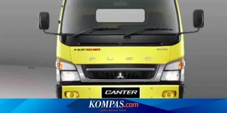 Truk Mitsubishi Fuso Canter warna kuning, tampilan depan.